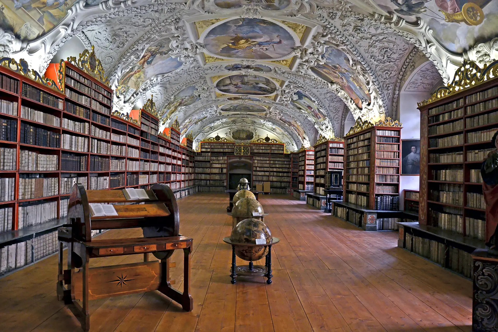 Photograph: historic library hall, books, painted ceiling